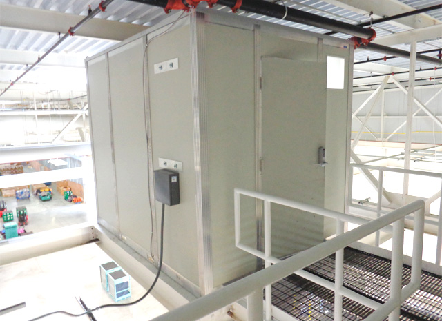 indoor enclosure to both protect delicate machinery from dirt and elements, and protect workers from machine hazards