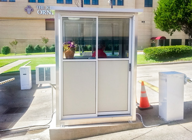 a small booth set at the gate of a monitored parking lot